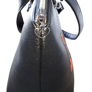 Detailed view of the heart-shaped zipper-pull against the black vinyl of the bag by just.a.tad accessories bag, sold by Gems from Paradise.