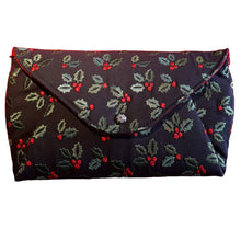 Clutch handbag, front view of bag in embroidered black linen blend fabric with embroidered green holly leaves and red berries, by just.a.tad accessories, sold by Gems from Paradise.