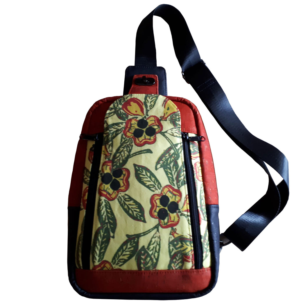 Front of the Ackee 1-2-3 Sling Mini Backpack showcasing the ackee print with cork, bag by just.a.tad accessories