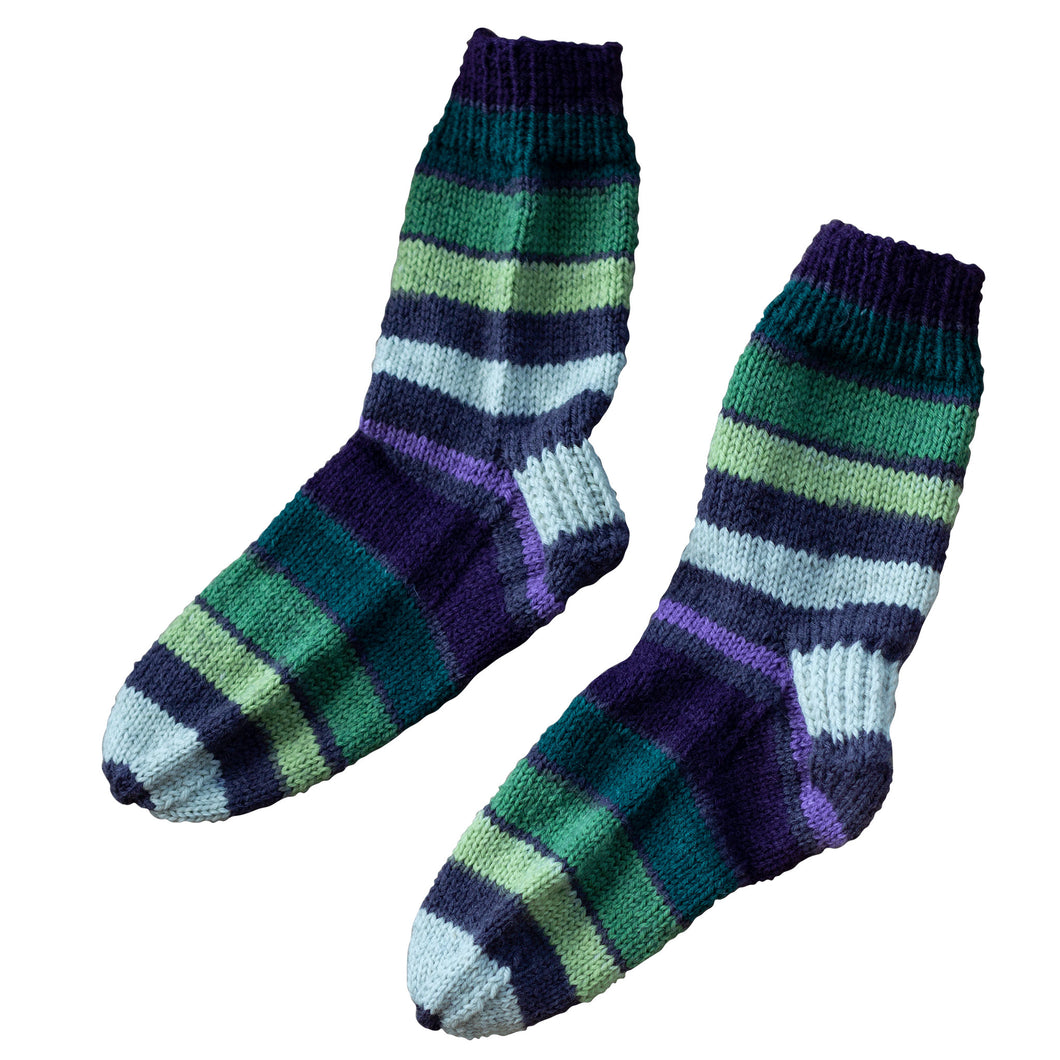 These handmade Socks by Sandy socks remind us of a grapevines with their variations of purple and green stripes and are sold by Gems from Paradise.