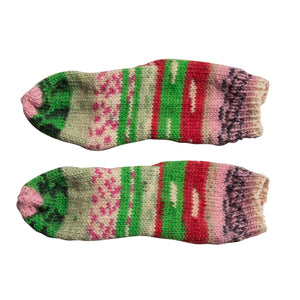 These sweet toddler-sized Rosy Vintage Christmas Socks are fun patterned stripes in pink, red and greens with cream and black accents scattered throughout. This is a flatlay view. 