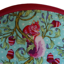 Dumpling-shaped Zip Pouch close up of fluffy-tailed squirrel and acorns in pinks and purples on blue background, by just.a.tad accessories, sold by Gems from Paradise.